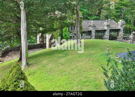 Rustic stone gazebo with shake roof on the forested grounds of Gillette Castle State Park in Connecticut. The eccentric stonework has been restored Stock Photo