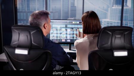 Working Analyst at Desktop PC with Spreadsheets Stock Photo