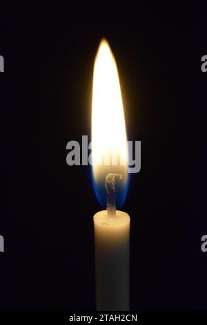 A single candle burning Stock Photo