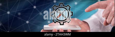 Settings concept above a smartphone held by a man Stock Photo