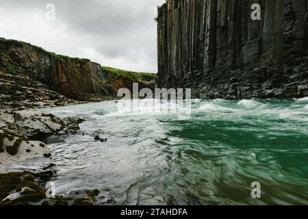 River flowing swiftly through basalt column ravine geothermal Stock Photo