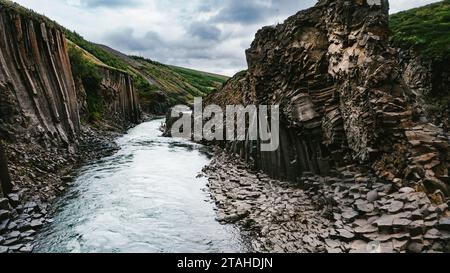 Glacial river going through basalt column gorge landscape Stock Photo