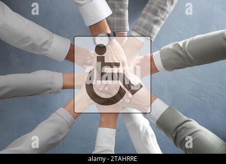 Inclusive workplace culture. International symbol of access. People holding hands together, top view Stock Photo