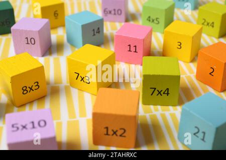 Colorful cubes with numbers and multiplications on yellow background Stock Photo
