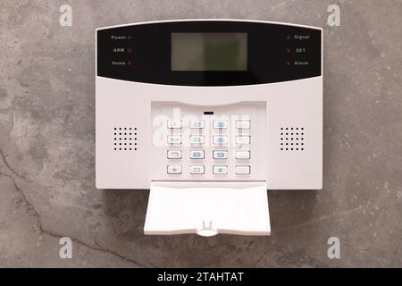 Home security alarm system on grey wall Stock Photo