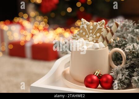 Delicious cocoa with marshmallows, wafer sticks and gingerbread cookie with Christmas decorations on white tray, space for text Stock Photo