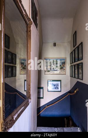 Watercolours by Stan Paget with rope in stairway of Georgian barn conversion, Tetbury, Gloucestershire, UK. Stock Photo