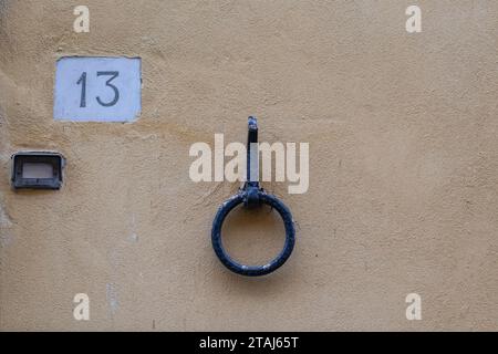 Blue metal ring hanging on the wall of building 13 Stock Photo