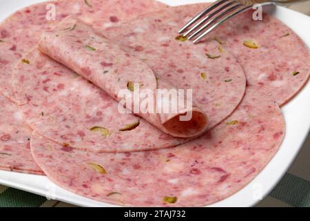 Plate with traditional Dutch zure zult, headcheese, slices close up Stock Photo