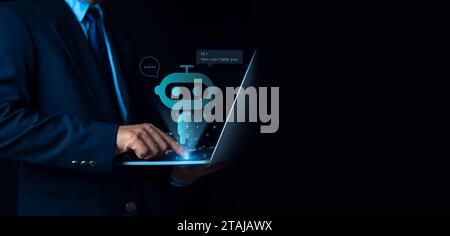 Businessman uses computer to type chat Ask and answer with the artificial intelligence system, chatbot, AI assistant. Stock Photo