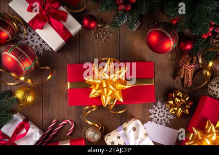 Decorating Christmas gifts background. Mother and child hands wrapping stack on New Year and Christmas gift boxes with festive ribbon, preparation for Stock Photo