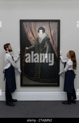 London, UK. 01st Dec, 2023. LONDON, UNITED KINGDOM - DECEMBER 01, 2023: Technicians look at a painting by Diego Rodriguez de Silva y Velazquez, Portrait of Isabel de Borbon, Queen of Spain, Full-Length, valued in region of $35m which will be offered at an auction at Sotheby's New York in February 2024 during a photocall at Sotheby's auction house in London, United Kingdom on December 01, 2023. (Photo by WIktor Szymanowicz/NurPhoto) Credit: NurPhoto SRL/Alamy Live News Stock Photo