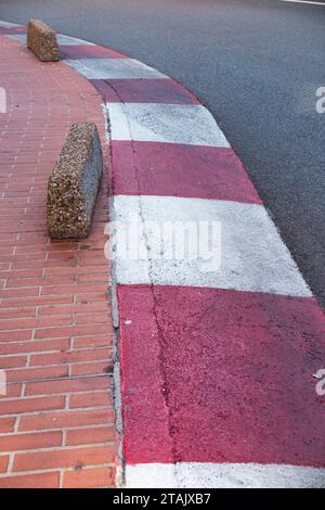 Monegaque red and white kerb stone / red & white racing style kerbs stones on the road, route of the Monaco Grand Prix Formula 1 race circuit. (135) Stock Photo