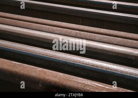 Many used rusty rails of different length stored at a ground for old ...