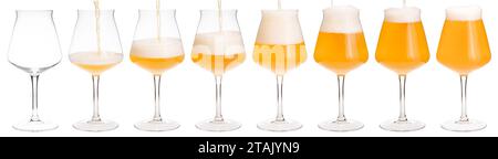 Hazy smoothie sour ale is pouring into tulip-shaped stemmed Tiku glass designed for a craft beer isolated on white background Stock Photo