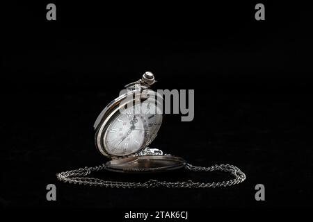 A silver pocket watch isolated on black background Stock Photo
