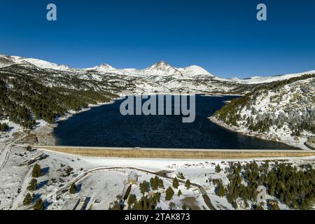 Aerial view of the Bouillouses lake after a snowfall in early winter. In the background, the Puig Peric peak (Pyrénées-Orientales, Occitania, France) Stock Photo