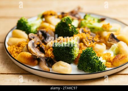 Gnocchi with Mushrooms Broccoli and Spicy Bread Crumbs Stock Photo