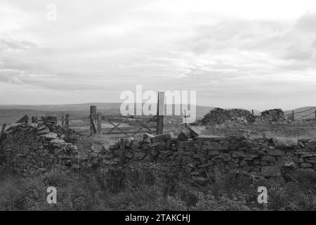 Wall in Slate depict a divided purpose built stone walls in contrast to a clear open skies Stock Photo