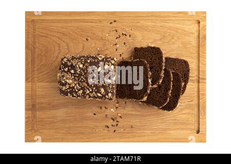 slices of rye bread on wooden board isolated on white background, top view, fresh delicious homemade healthy baking, bread with seeds and crumbs cut i Stock Photo
