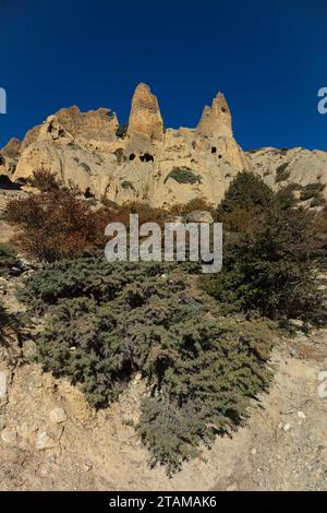 Hoodoo formations contain caves carved by humans 3000 years ago near Yara village - upper Mustang District, Nepal Stock Photo