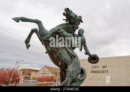 Prescott, AZ - Nov. 15, 2023: 'Early Rodeo' bronze sculpture by Richard Terry commemorates 100 Years of Rodeo. The sculpture stands in front of Presco Stock Photo