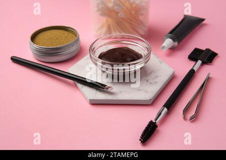 Eyebrow henna and tools on pink background Stock Photo