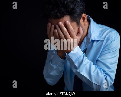 Businessman acted tired headache stressed and anxious from the frustrated business crisis, expresses disappointment, regret, making a mistake. Stock Photo