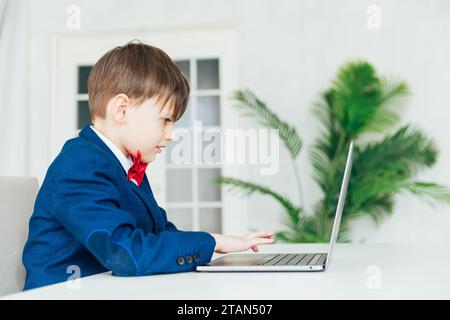 Business boy in jacket sitting at laptop Stock Photo