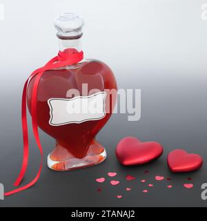 Love potion magical concoction or perfume gift in heart shaped bottle with red heart decorations on gradient gray. Valentines Day lovers abstract. Stock Photo