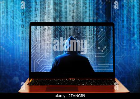 hacker in hood inside a laptop computer, cyber attack, phishing and data breach concept Stock Photo