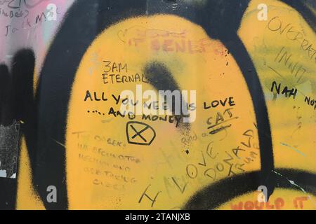 Graffiti on a house wall - All you need is Love and Money Stock Photo