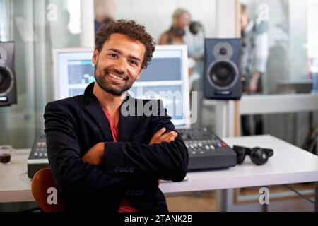 DJ, arms crossed and recording studio portrait with a man and music producer with tech and computer. Sound engineer, audio technician and media with a Stock Photo