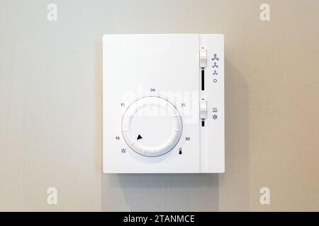 Air conditioner control panel for room climate system mounted on the wall. Stock Photo