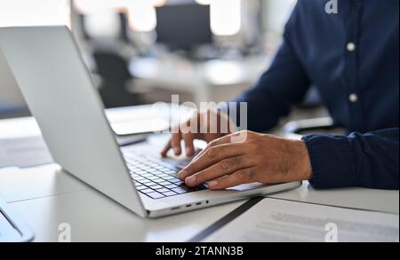 Hands of business man typing on laptop working with ai solutions on computer. Stock Photo