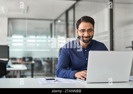Busy professional business man company employee using laptop working in office. Stock Photo