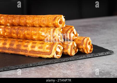 Homemade waffles with caramel.  Wafer rolls with condensed milk. Thin and Crispy Waffle Stock Photo