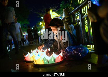Young man with shopping bags on street at night Stock Photo