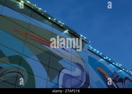 Detail of Ecology Triptych mural, and Christmas lights, on a building in Rochester Michigan USA Stock Photo