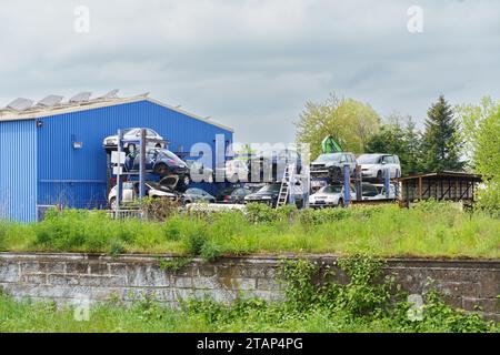 Friesenheim, Germany - April 29, 2023: Recycling of old, used, wrecked cars. Dismantling for parts at scrap yards and sending for remelting. Stock Photo