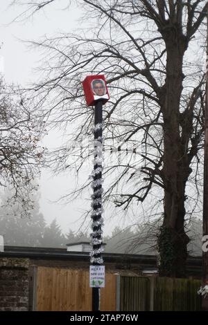 Harefield, UK. 2nd December, 2023. Anti Ultra Low Emission Zone (ULEZ) 'Blade Runners' have been busy in Harefield in the London Borough of Hillingdon. They have covered a ULEZ camera with a red box and a picture of Sadiq Khan wearing a bow tie. The pole is also wrapped in Christmas tinsel with a sign saying 'Merry Non-ULEZ Christmas. The Conservative Mayoral Candidate, Susan Hall, commenting on a recent report on ULEZ said that it 'proves once again that Sadiq Khan's ULEZ expansion is nothing but a tax grab'. Credit: Maureen McLean/Alamy Live News Stock Photo