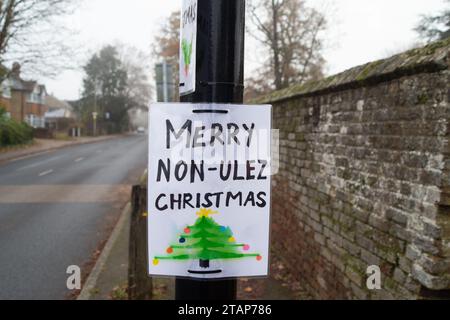 Harefield, UK. 2nd December, 2023. Anti Ultra Low Emission Zone (ULEZ) 'Blade Runners' have been busy in Harefield in the London Borough of Hillingdon. They have covered a ULEZ camera with a red box and a picture of Sadiq Khan wearing a bow tie. The pole is also wrapped in Christmas tinsel with a sign saying 'Merry Non-ULEZ Christmas. The Conservative Mayoral Candidate, Susan Hall, commenting on a recent report on ULEZ said that it 'proves once again that Sadiq Khan's ULEZ expansion is nothing but a tax grab'. Credit: Maureen McLean/Alamy Live News Stock Photo