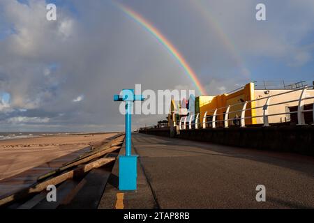 Rainbow over the beach and promenade at Prestatyn, North Wales Stock Photo