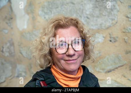 portrait of attractive smiling senior woman with blonde hair and glasses Stock Photo