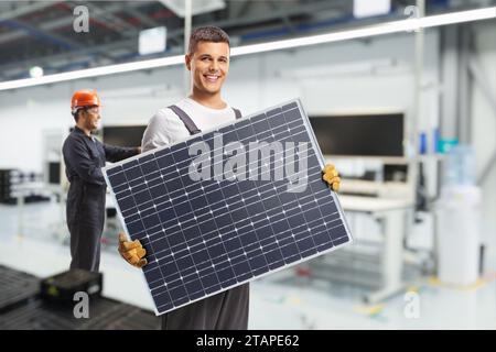 Solar panel manufacturing technology, workers at production line Stock Photo