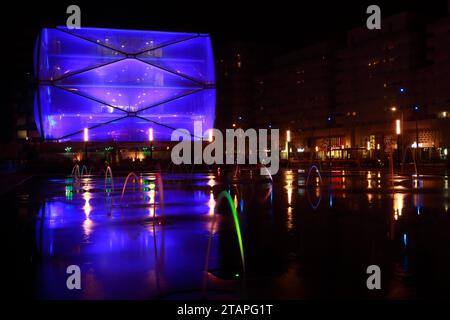 Water Mirror and Le Nuage building by night designed by Philippe Starck , Parvis Stephane Hessel, Montpellier, France Stock Photo