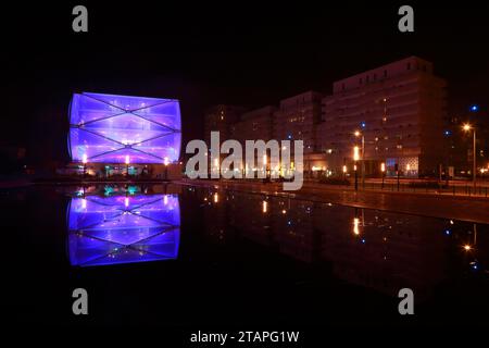 Water Mirror and Le Nuage building by night designed by Philippe Starck , Parvis Stephane Hessel, Montpellier, France Stock Photo