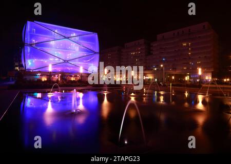 Water Mirror and Le Nuage building by night designed by Philippe Starck , Parvis Stephane Hessel, Montpellier, France Stock Photo