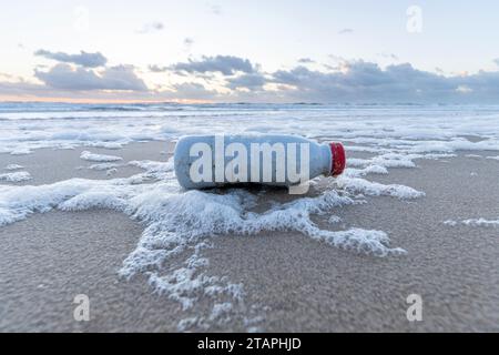 plastic waste on sandy beach Stock Photo