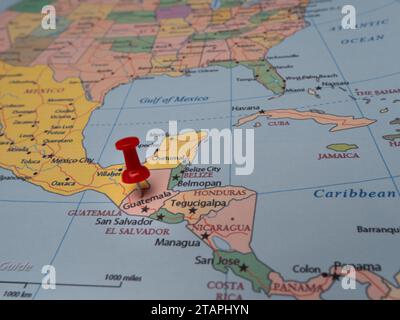 A close-up of a world map with a pin pointing to the location of Belize ...